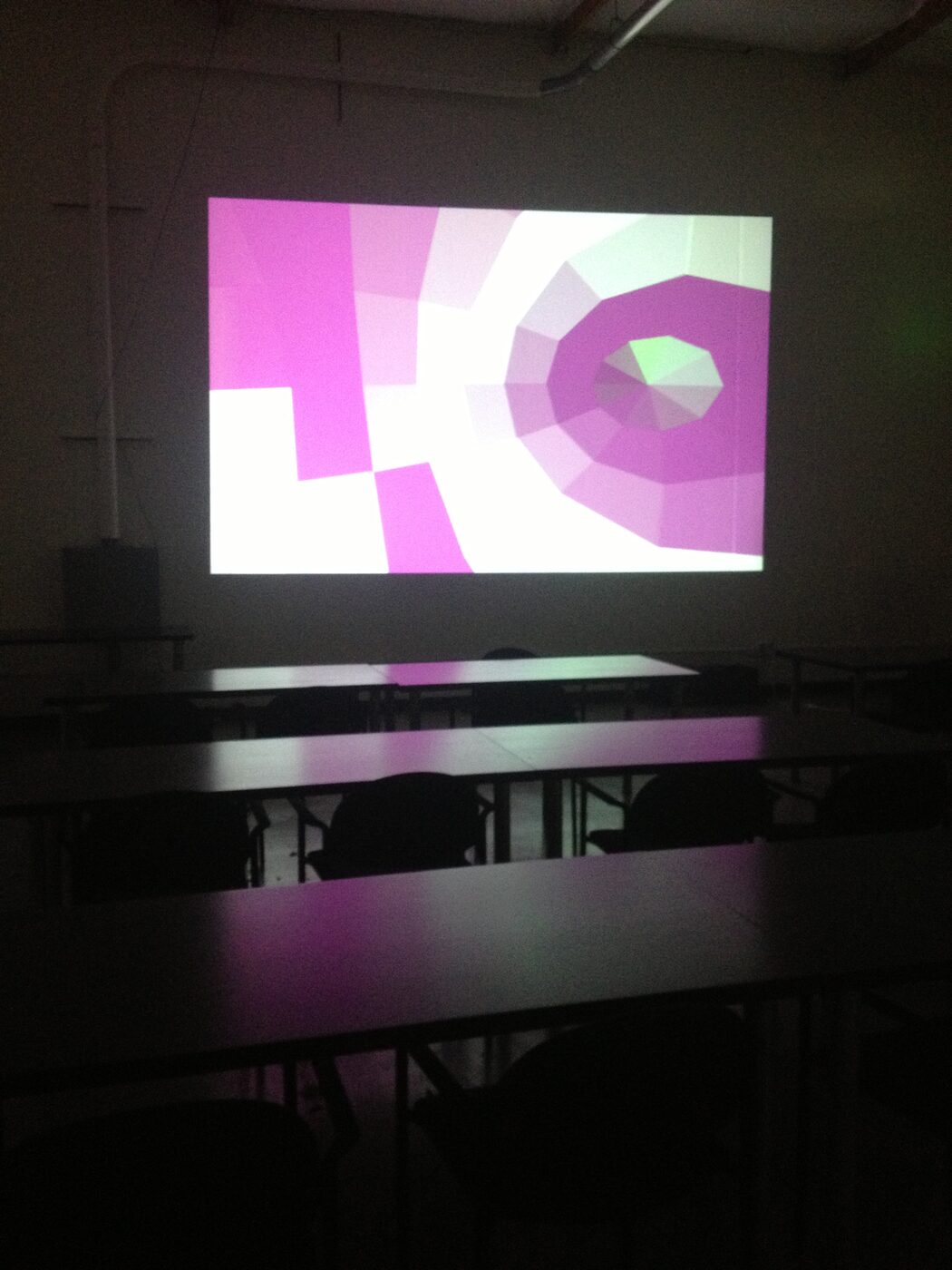 Two secondhand projectors on a workshop floor beside coiled cables